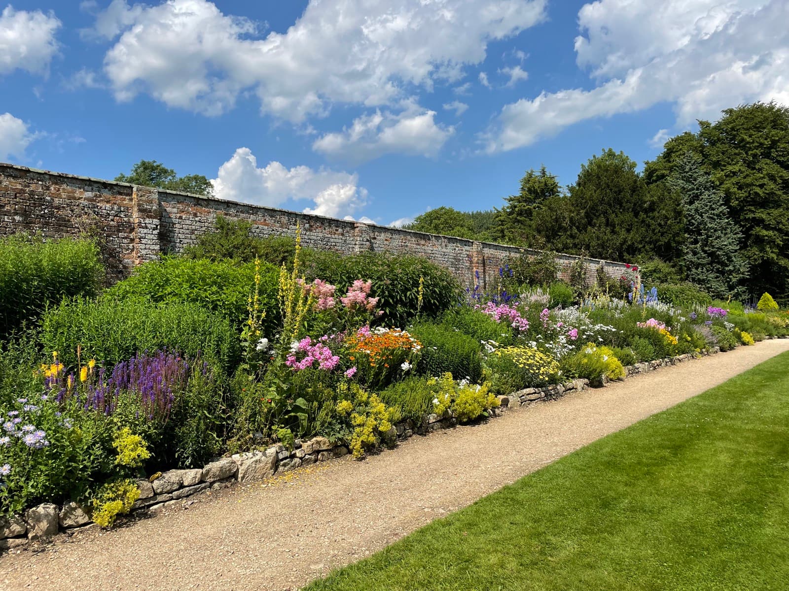 A flowering border beside a lawn at Waterperry